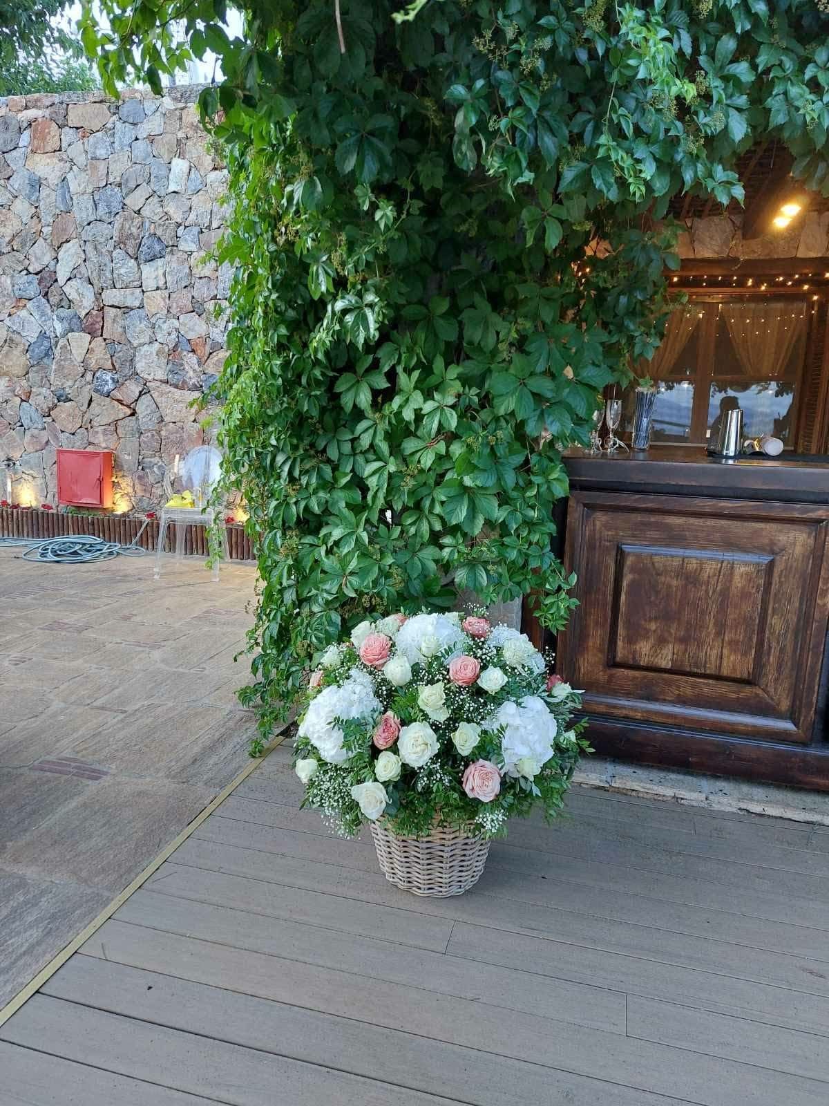 Textural flower basket arranged against a stone villa wall