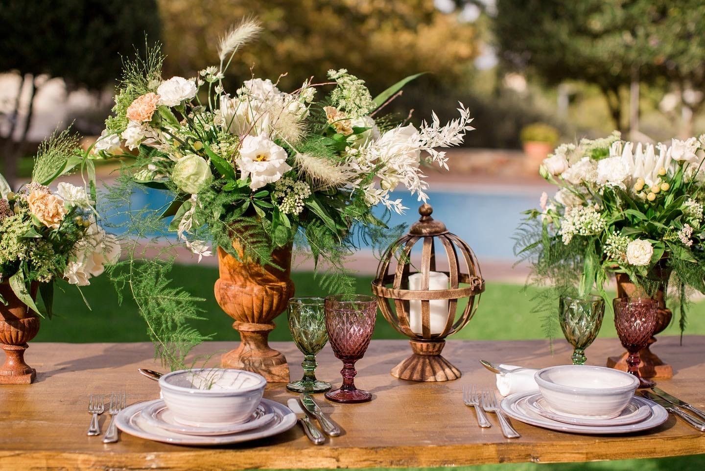 Poolside villa dinner flowers at sunset