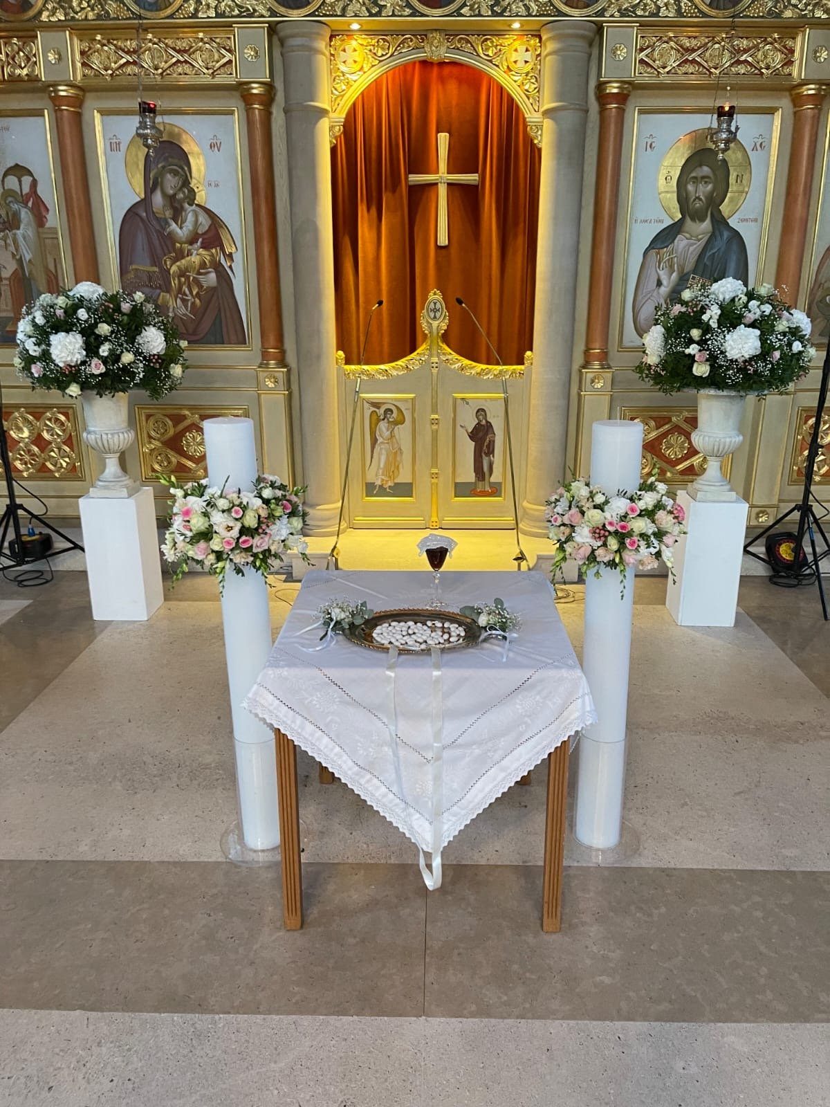 Blush and ivory wedding flowers arranged at an Orthodox church in Athens