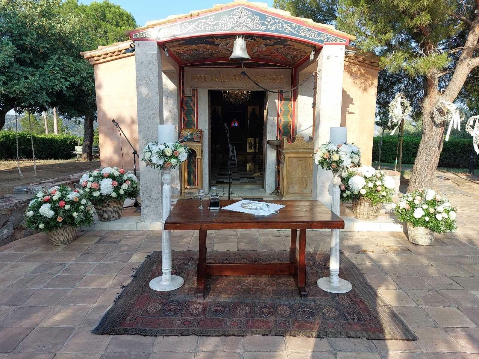 White and green floral design at a private chapel wedding in Greece